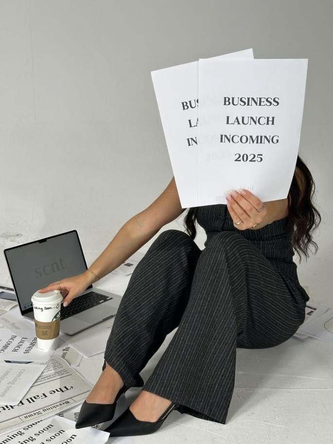 Seated woman holding a brand planning publication